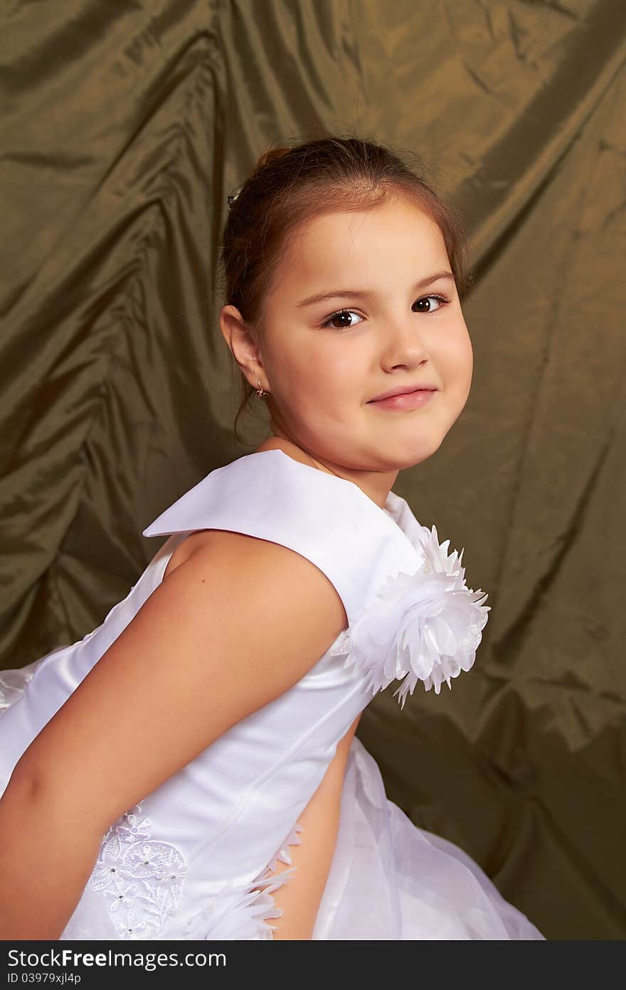 A little girl sits pensively in white dress. A little girl sits pensively in white dress.