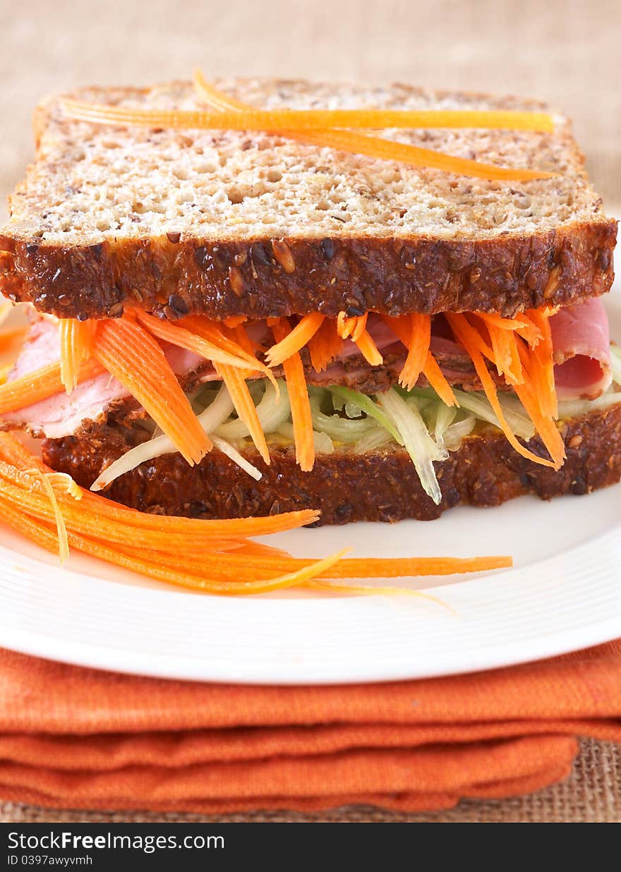 Tasty open sandwich with cucumber relish, smoked beef pastrami and sliced carrots on wholewheat bread. Tasty open sandwich with cucumber relish, smoked beef pastrami and sliced carrots on wholewheat bread