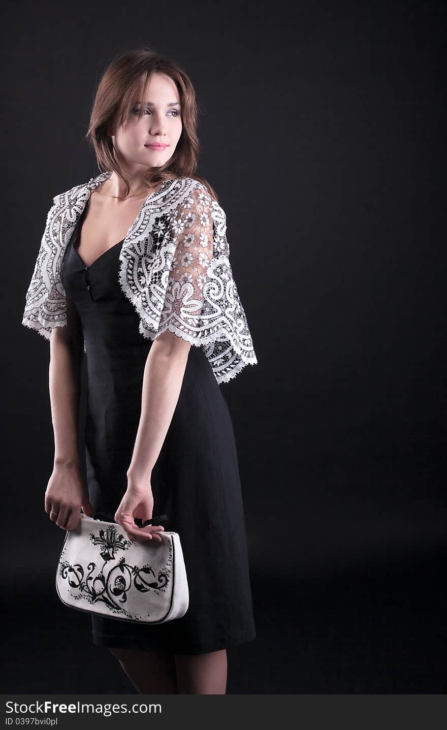 Beauty young woman in lacy jacket and handbag