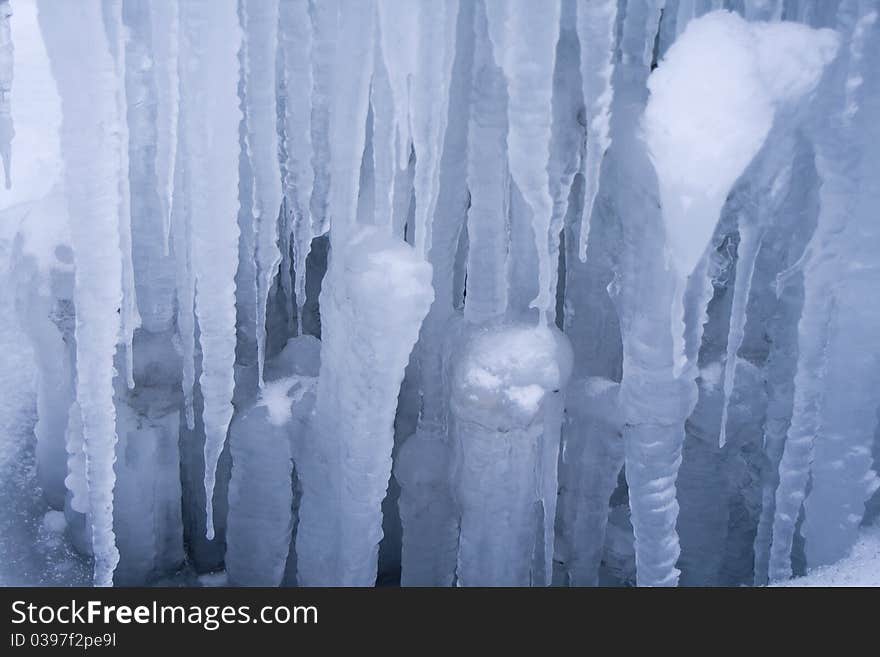 Blue icicles background with little snow