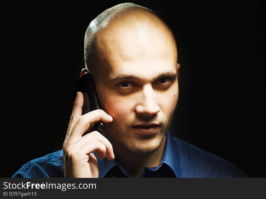 A studio shoot of a young handsome man with phone