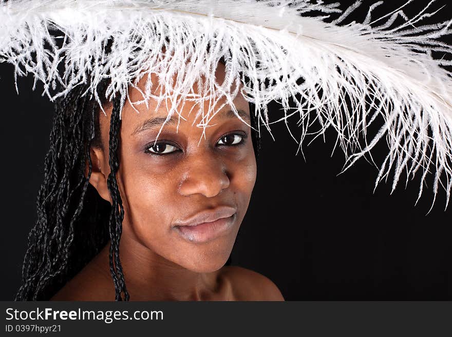 Afro-american woman with white feather against black background. Afro-american woman with white feather against black background