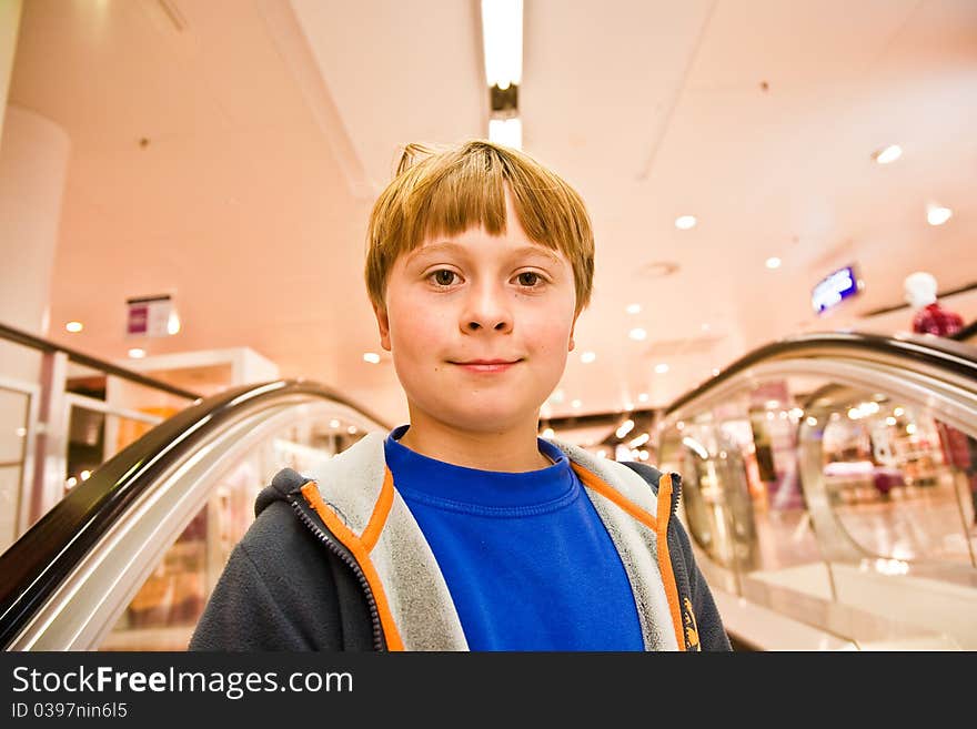 Child on moving staircase looks self confident