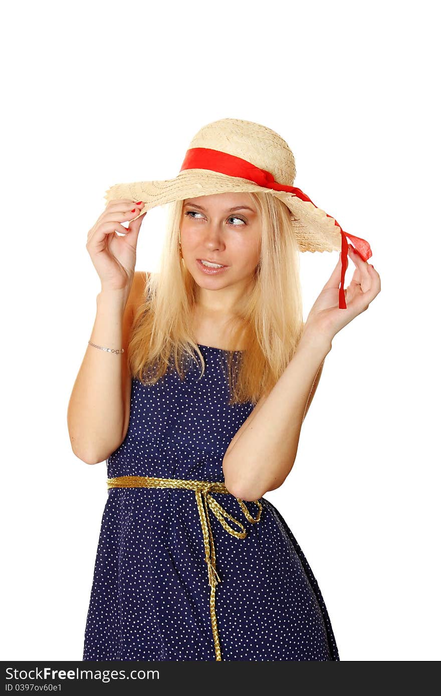 Beautiful young blond woman in a straw hat and a blue light summer dress.