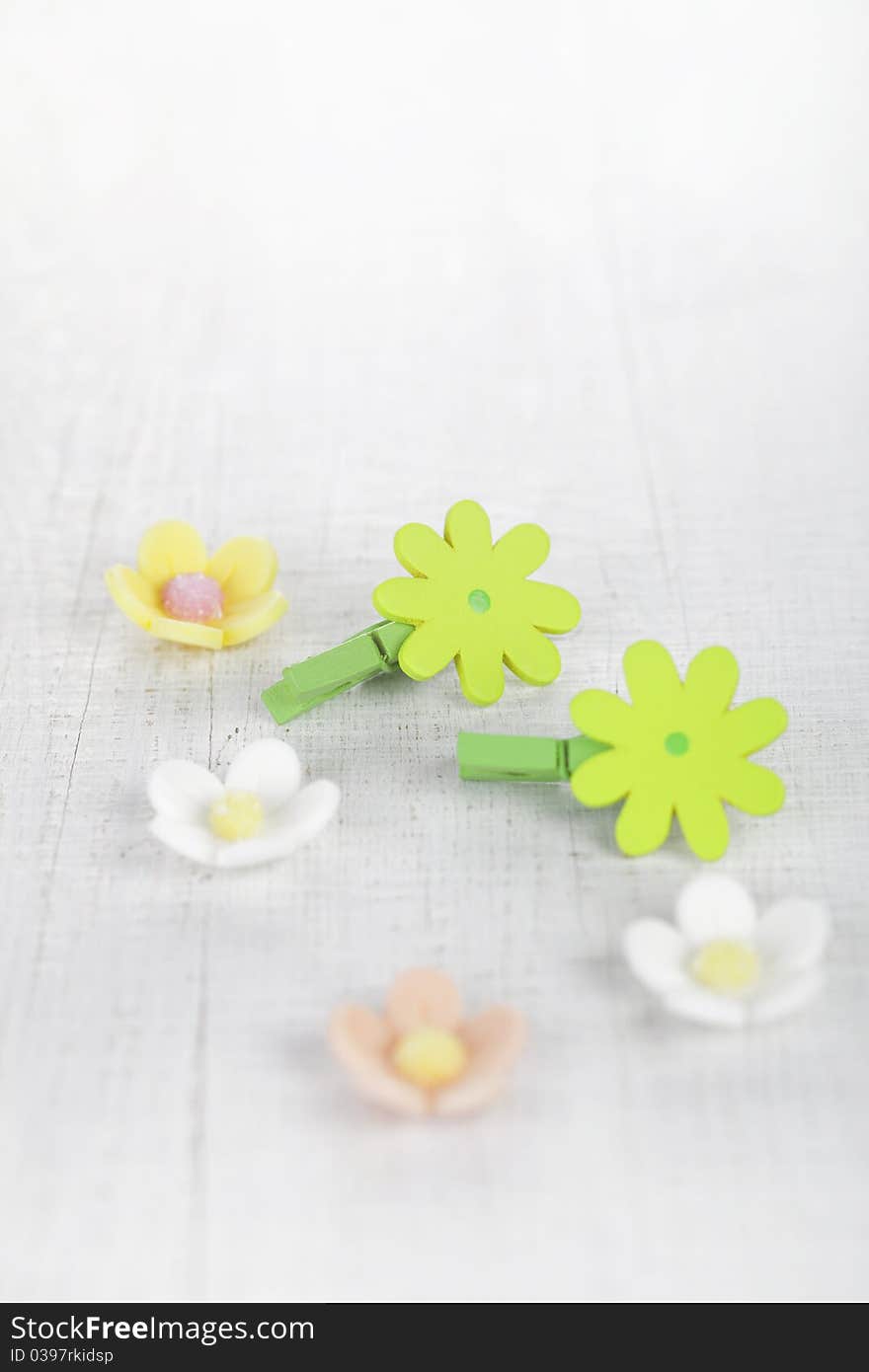 Decorative flower pegs with sugar flowers on white old table