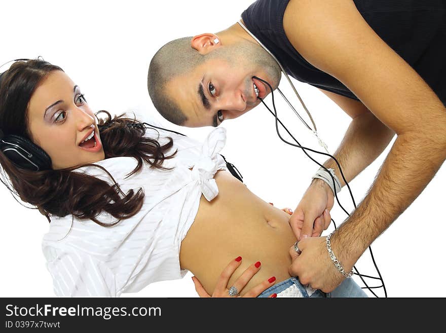 Young couple with headphones and crazy fun isolated on white. Young couple with headphones and crazy fun isolated on white