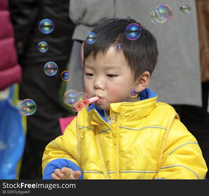 A cute child blowing soap bubbles. A cute child blowing soap bubbles