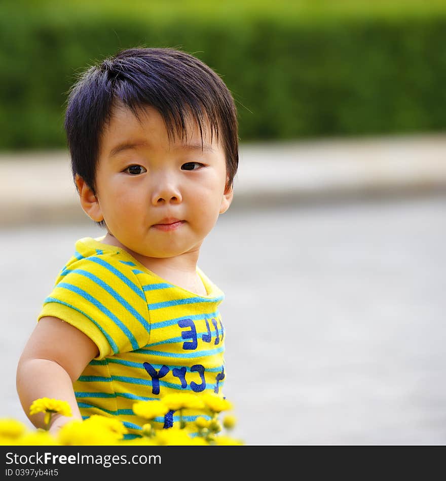 A cute baby is playing in garden