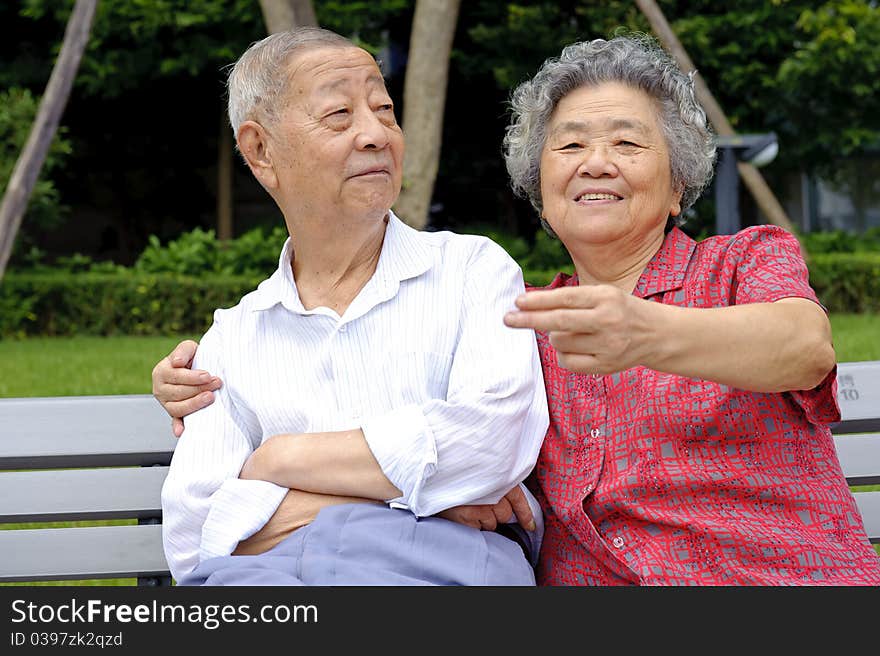 An intimate senior couple in a garden. An intimate senior couple in a garden