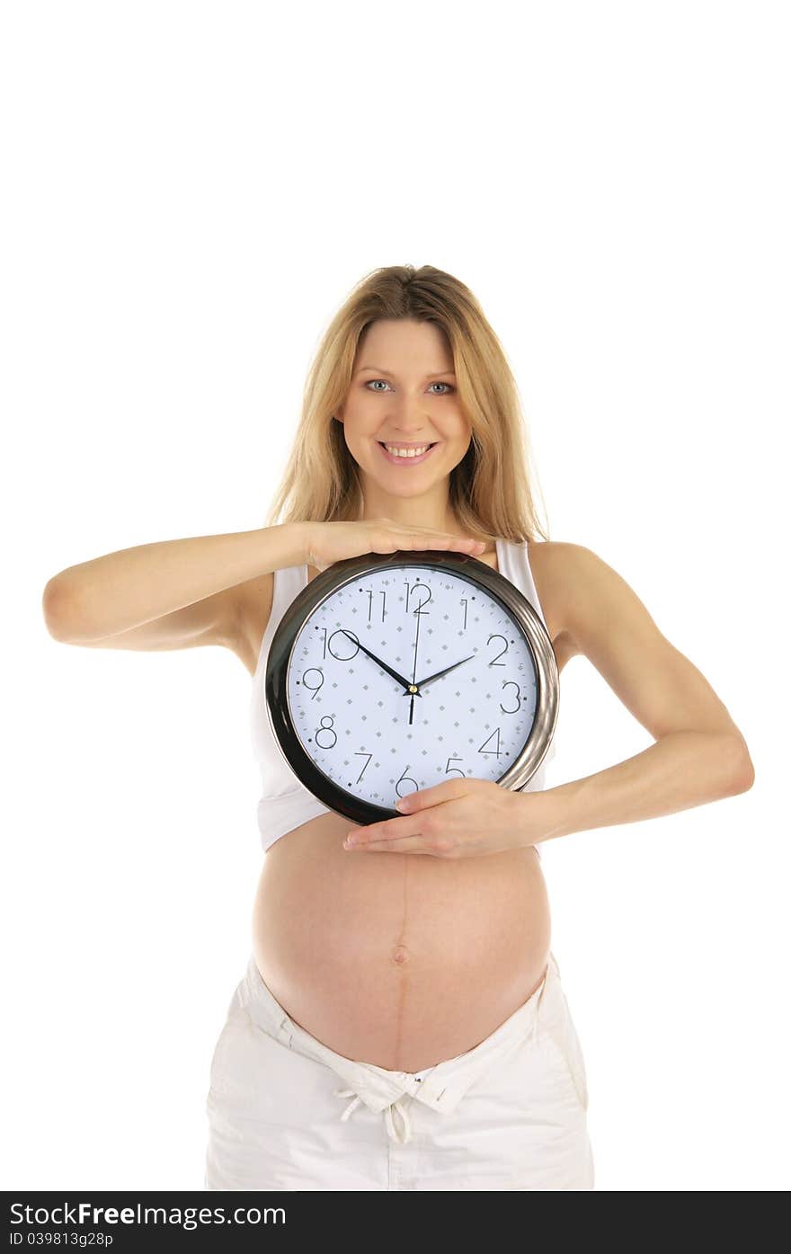 Happy pregnant woman with a round clock