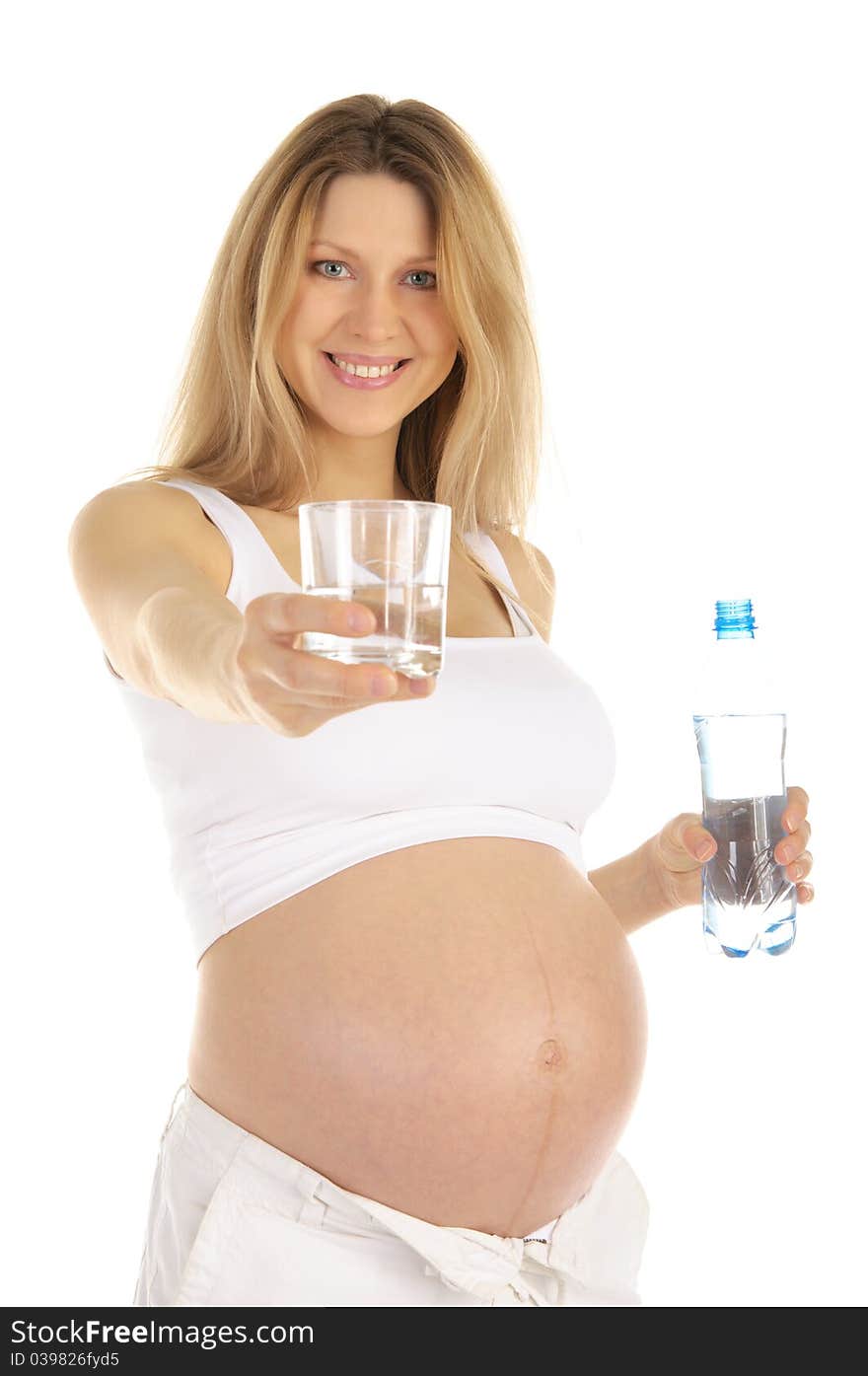 Pregnant woman holds out a glass of water isolated on white