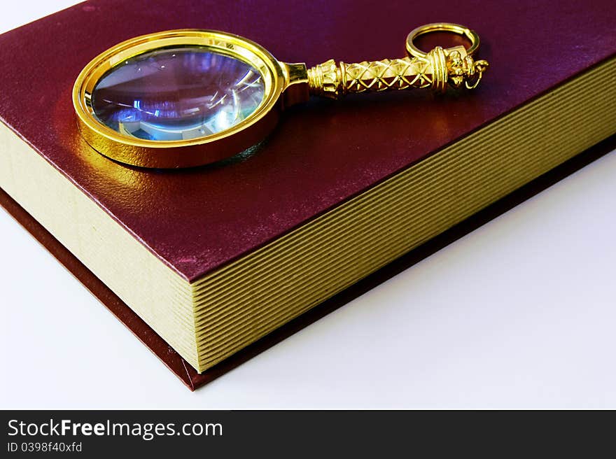 Book and magnifying glass