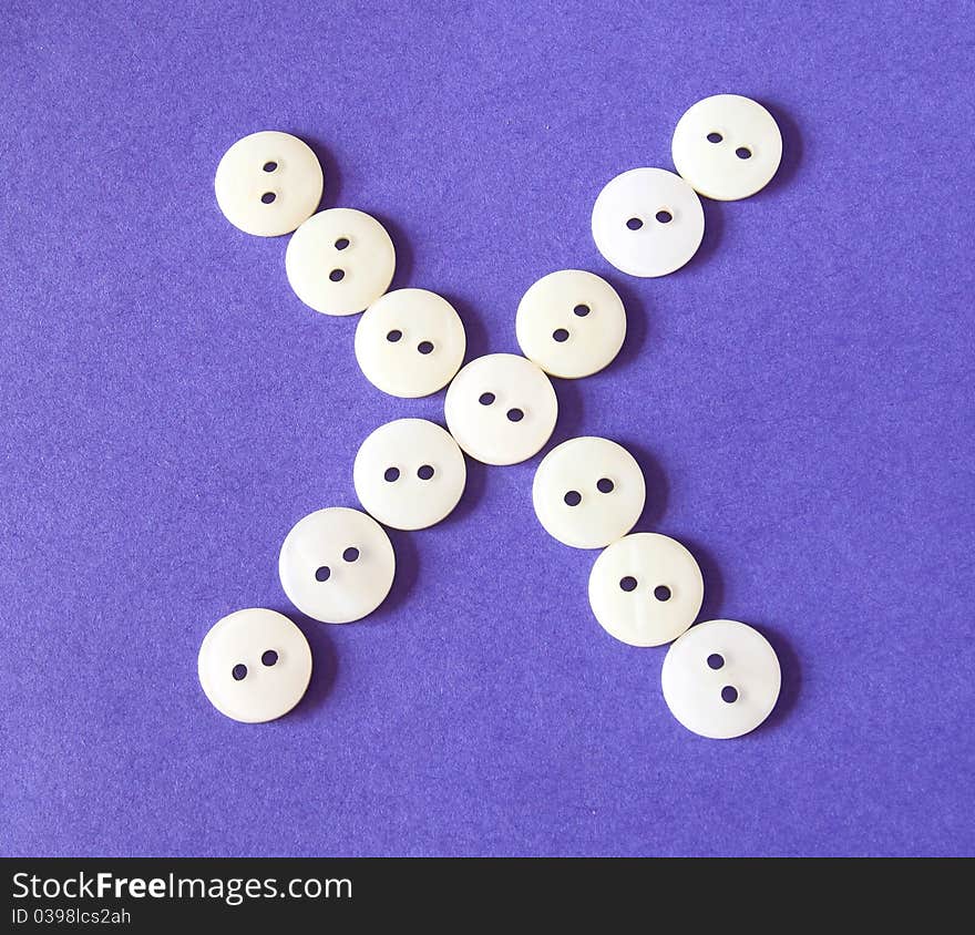 Figure cross icon from white buttons on purple background