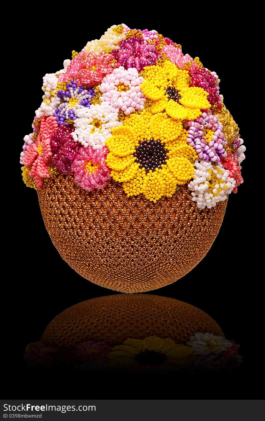 Egg decorated with beads on black background with reflection. Egg decorated with beads on black background with reflection