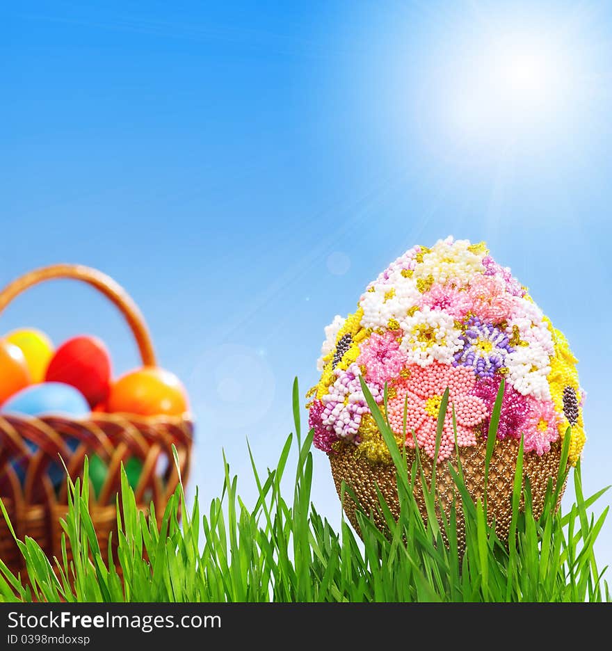 Egg decorated with beads in green grass. Egg decorated with beads in green grass