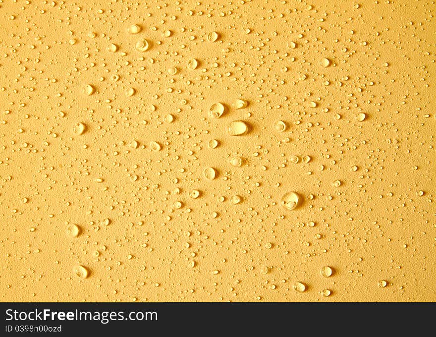 Drops Of Water On Yellow Background