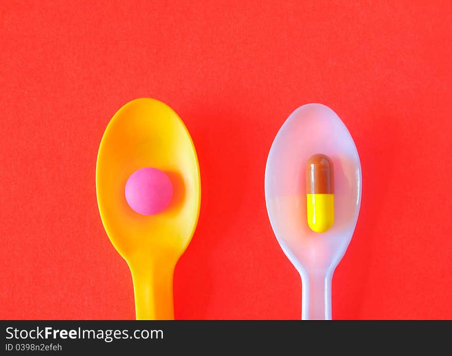 Spoonful of Pills on red backgroun