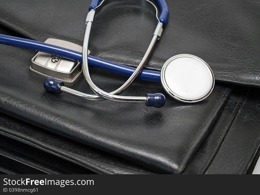 Stethoscope and the bag in black, close-up. Stethoscope and the bag in black, close-up.