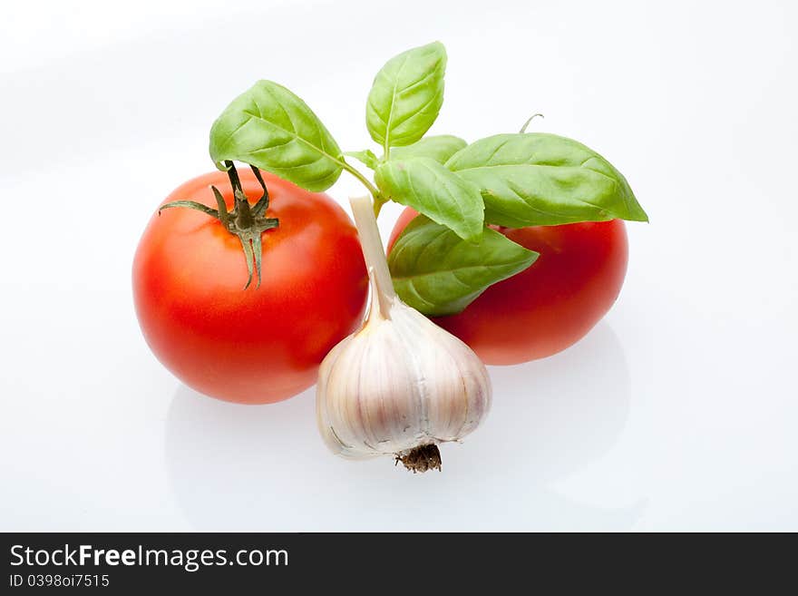 Tomato, mint and garlic on a light background. Symbols of Mediterranean cuisine