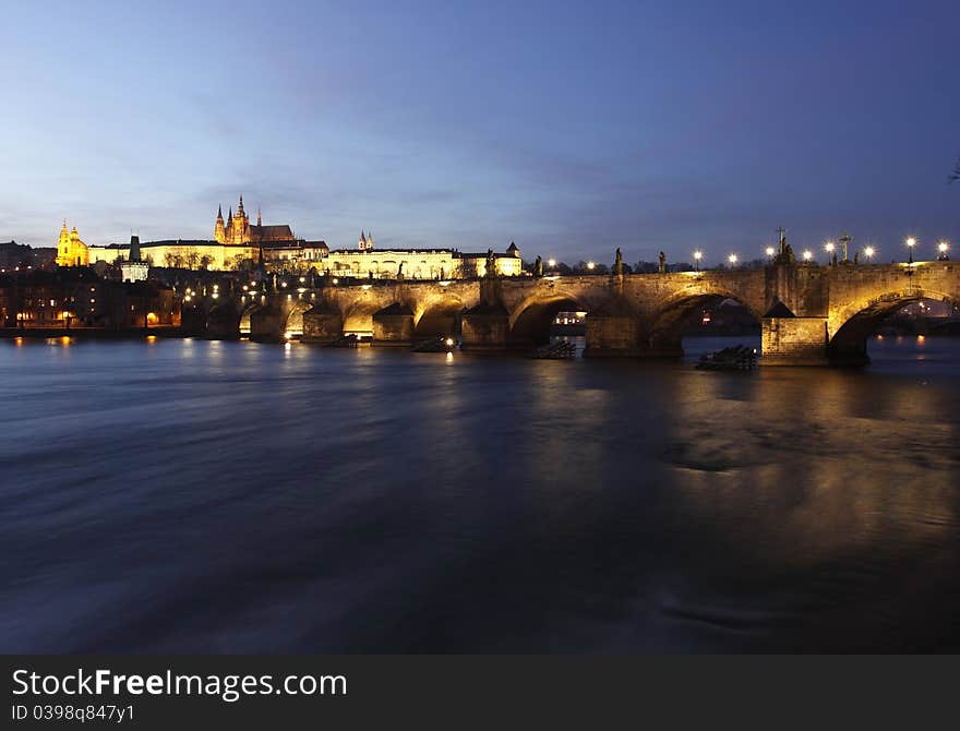 The Prague Castle and Charles Bridge as as two main landmark in Prague at sunset.