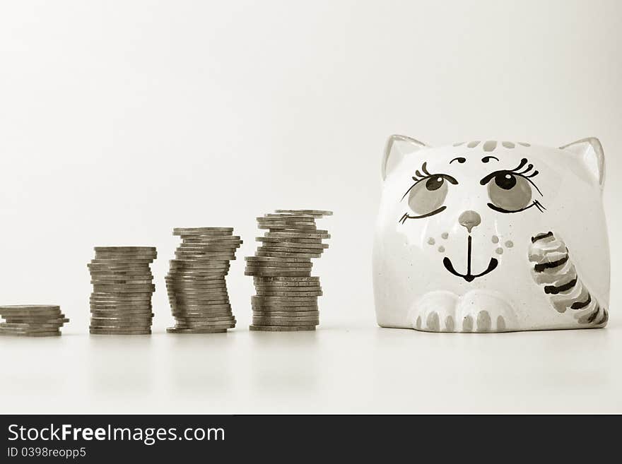 Coins and money bank on a white background