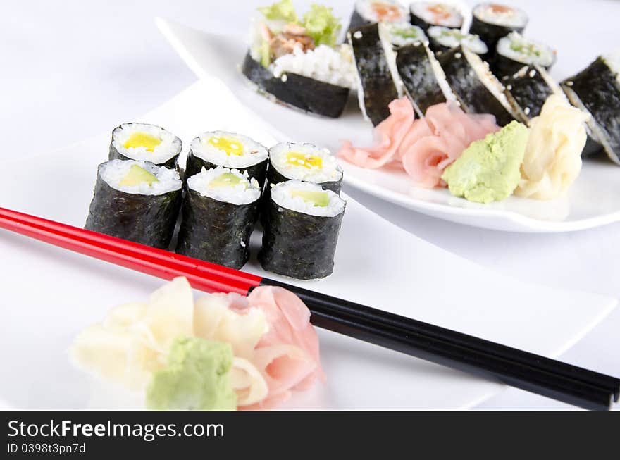 Sushi on white plates and a white background