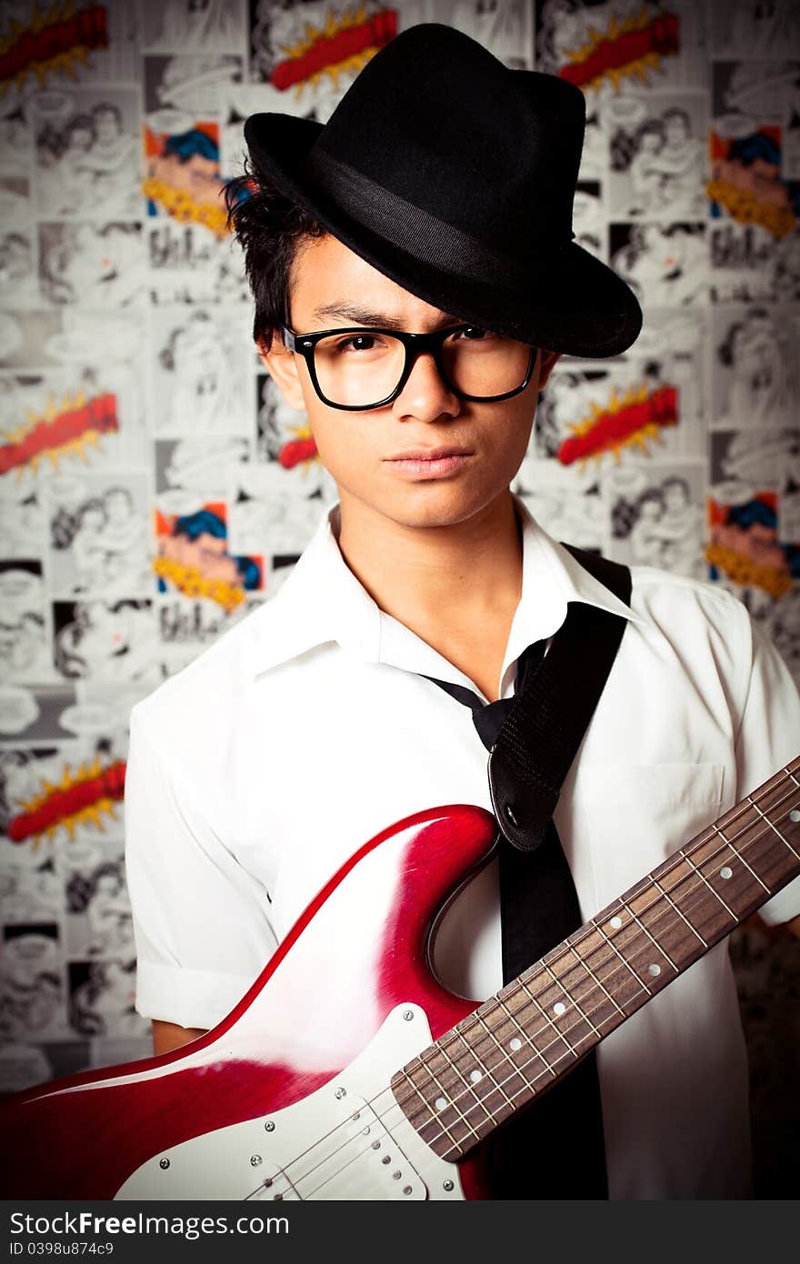 A young man holding guitar. A young man holding guitar