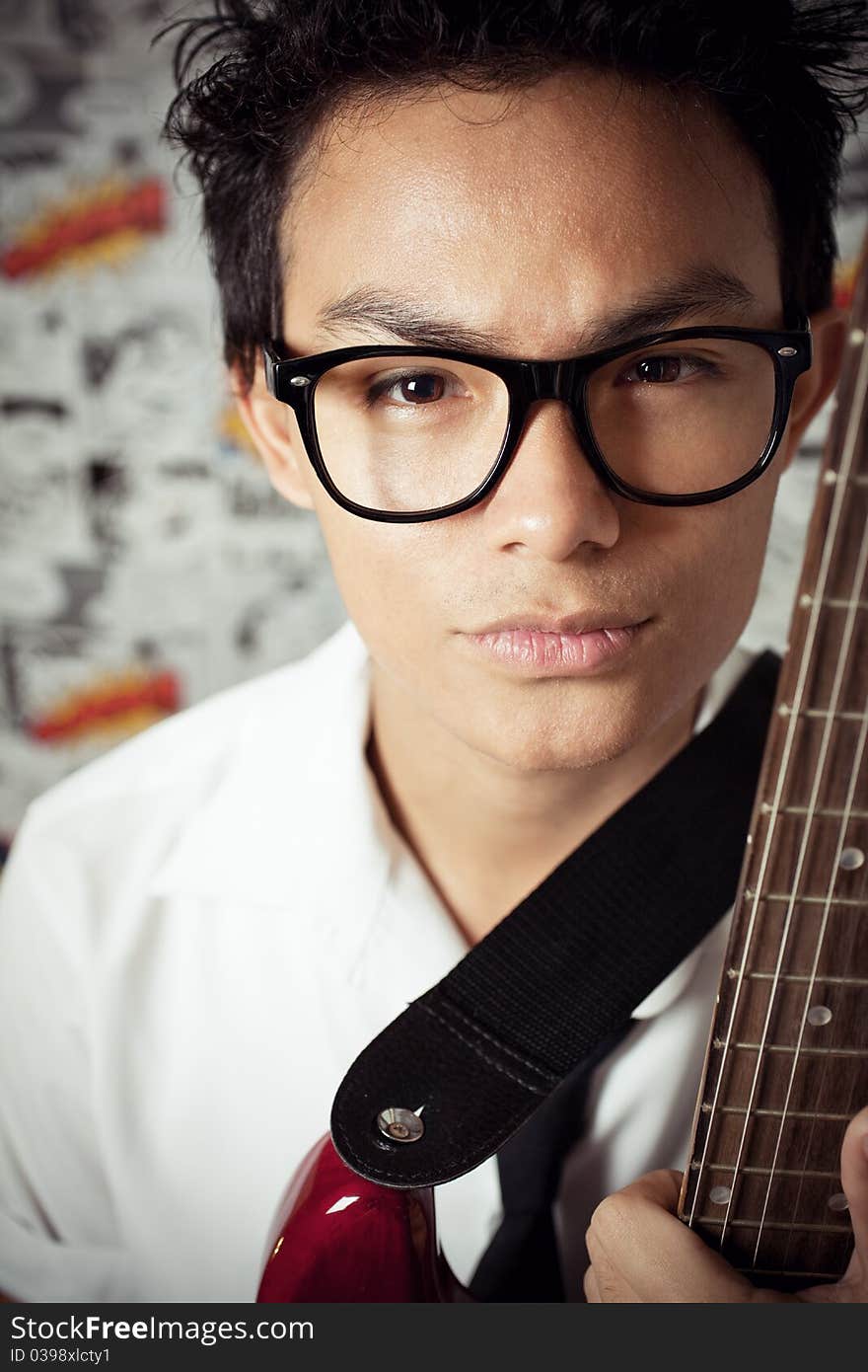 A young man holding guitar. A young man holding guitar