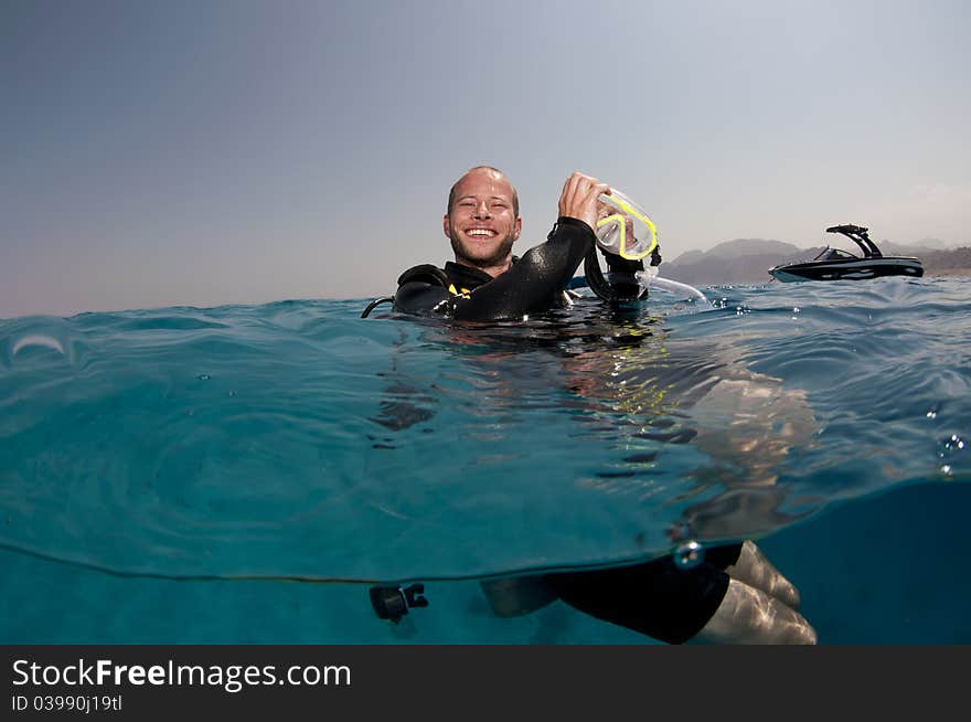 Scuba Diver On Surface Of Water