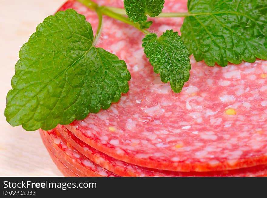 Salami as a close-up with herbs.