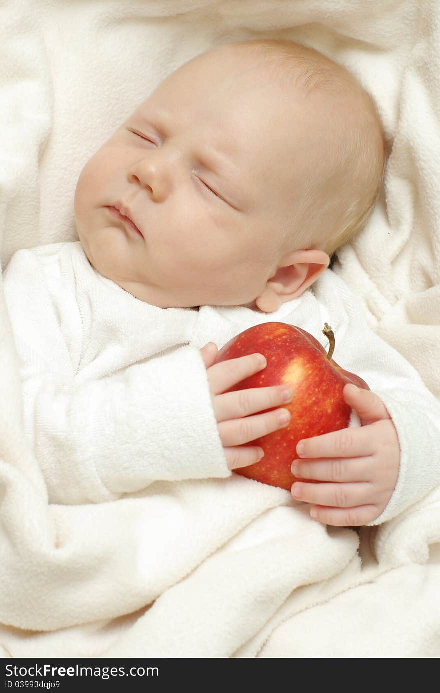 Cheerful baby with big apple