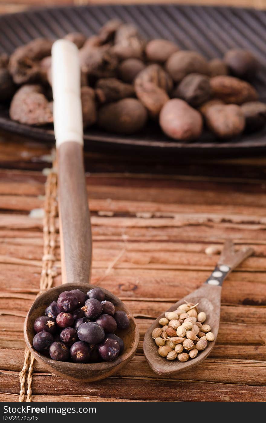 Two wooden spoon full with spices. Two wooden spoon full with spices