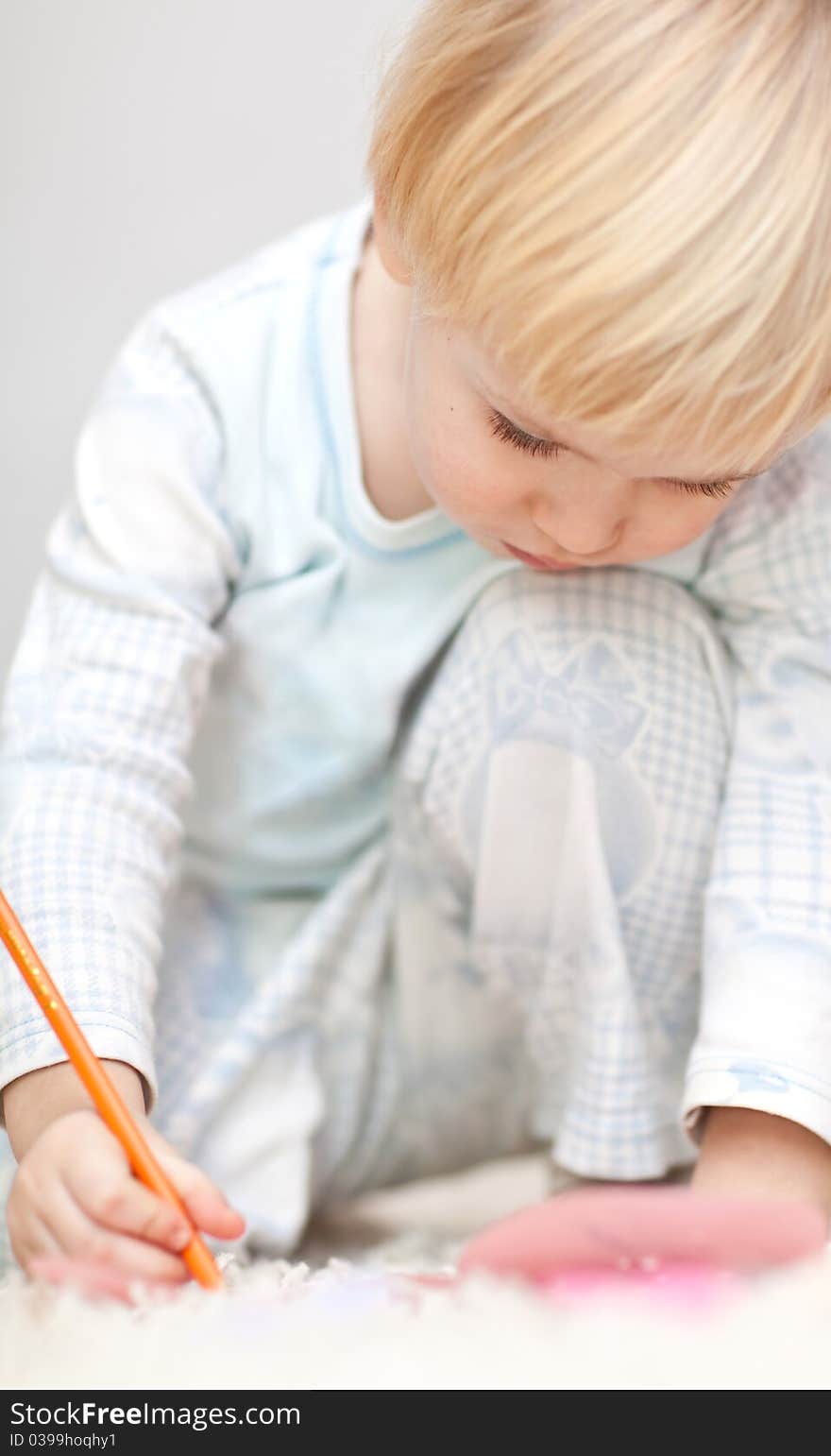 Nice little boy writting something on the floor