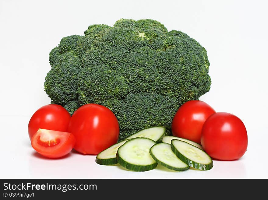 Fresh broccoli, cucumber and tomato on a white background. Fresh broccoli, cucumber and tomato on a white background