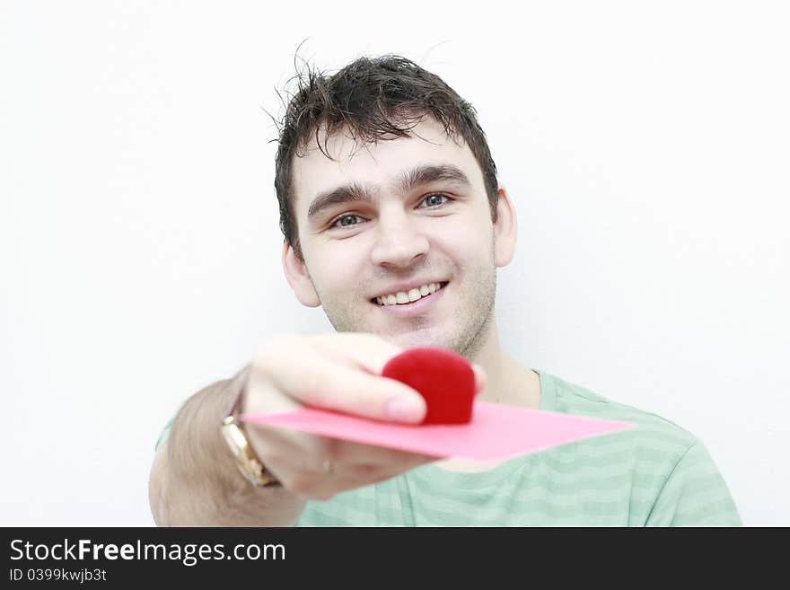 Young man giving a red little box