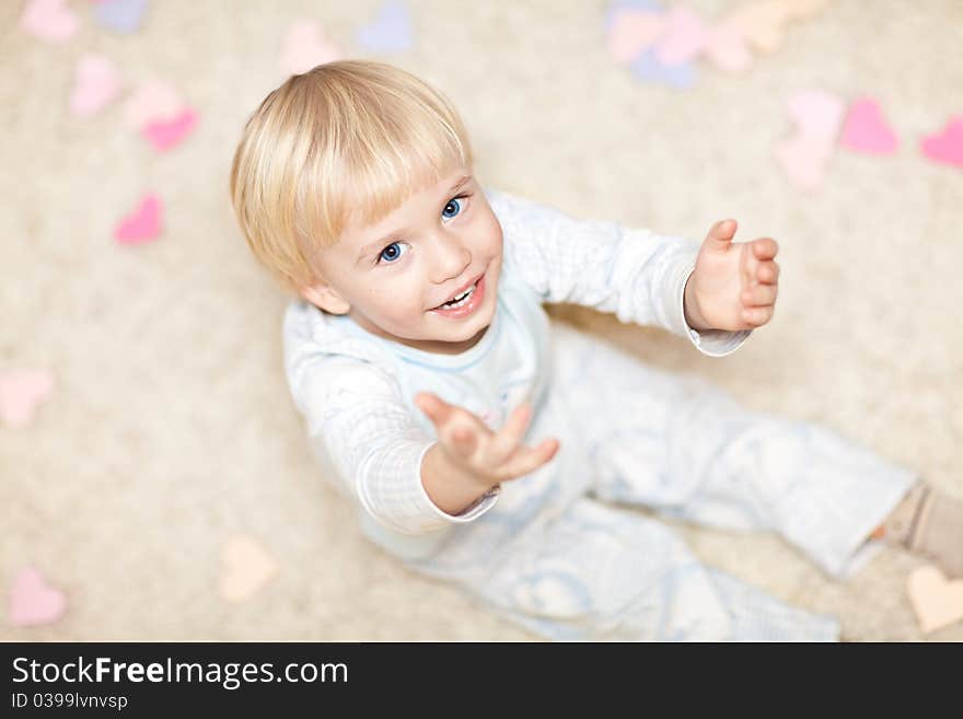 Sweet Little Boy Sitting On The Floor