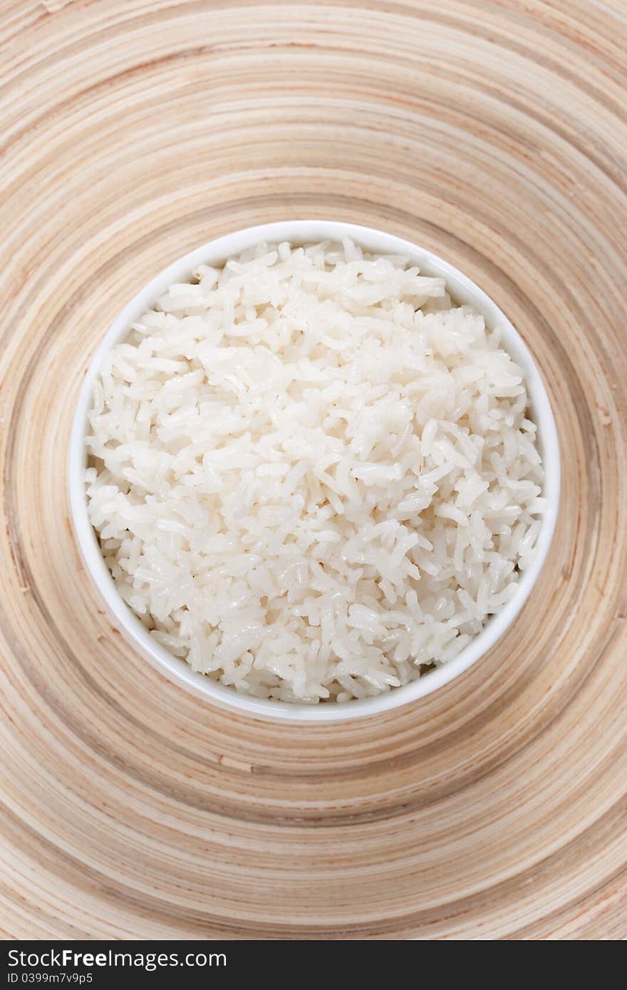 Rice in a bowl on a bamboo plate. Concept of the importance of rice