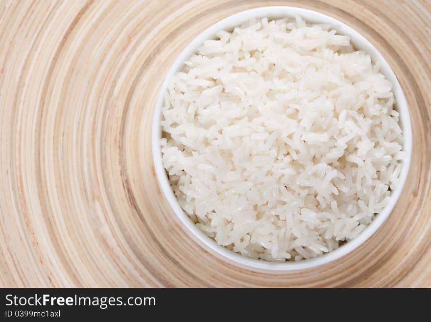 Rice in a bowl on a bamboo plate. Concept of the importance of rice