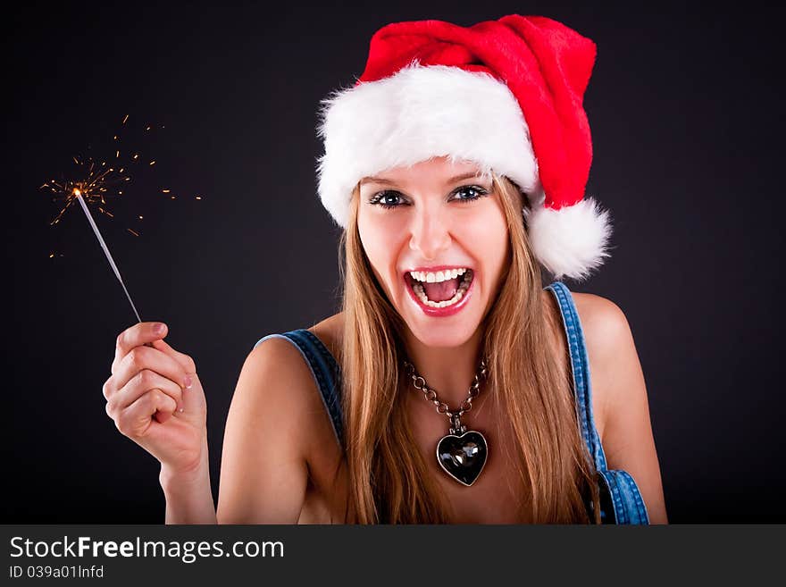 Cute girl in Santa hat holding sparklers. Cute girl in Santa hat holding sparklers