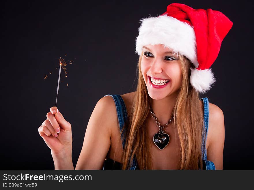 Cute girl in Santa hat holding sparklers. Cute girl in Santa hat holding sparklers