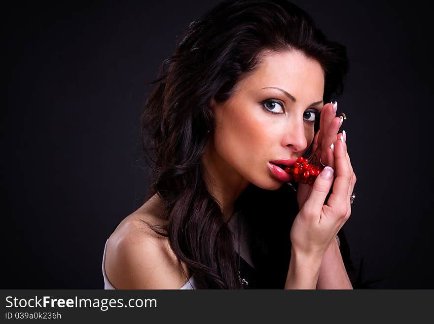 Sexy girl with a branch of viburnum in her hands