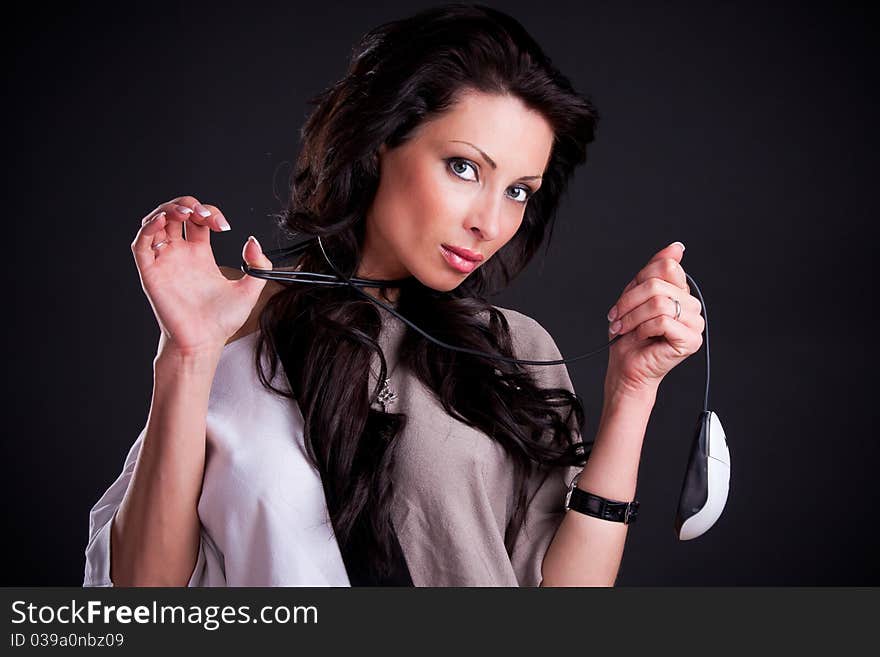 Attractive girl entwined cord holding a computer mouse