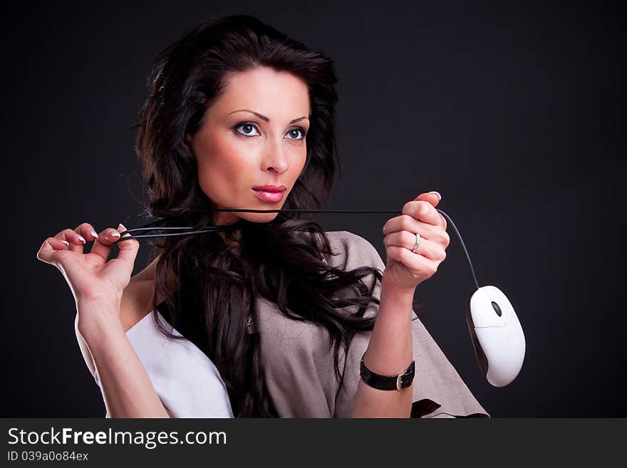 Attractive girl entwined cord holding a computer mouse