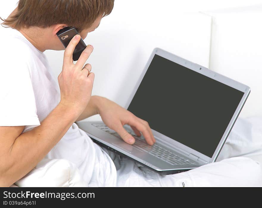 Rear view closeup of a young man working of a laptop