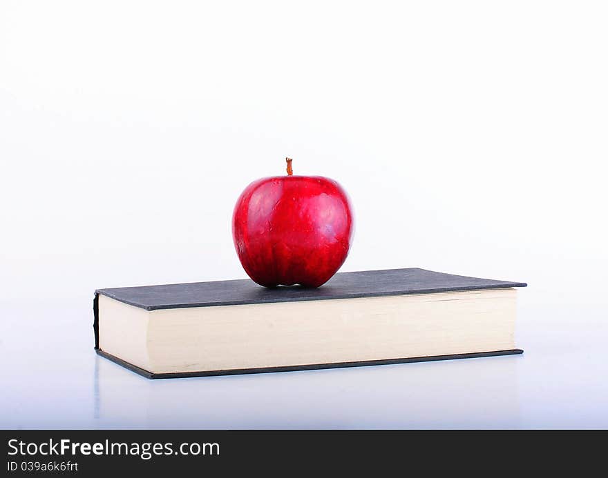 A apple on a black book. A apple on a black book