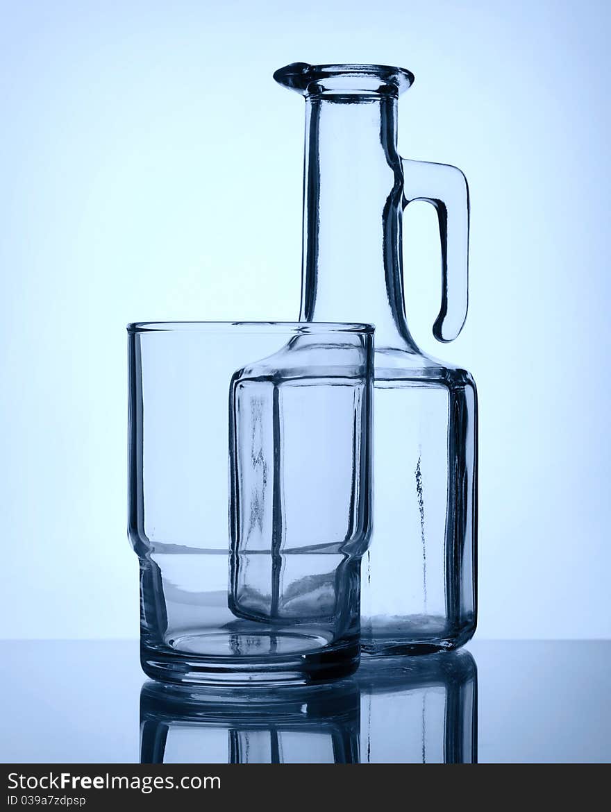 Empty glass and old stile bottle, still life, monochromatic