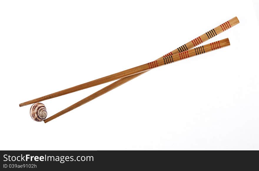 Chopsticks and snail isolated on white background