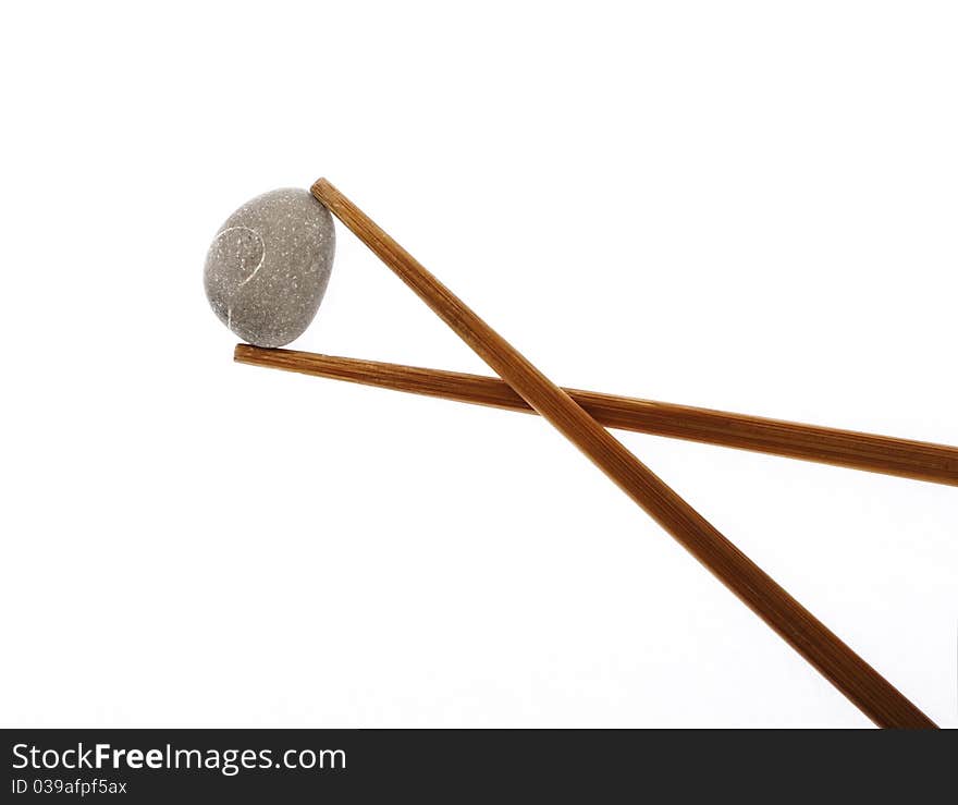 Chopsticks and stones isolated on white background