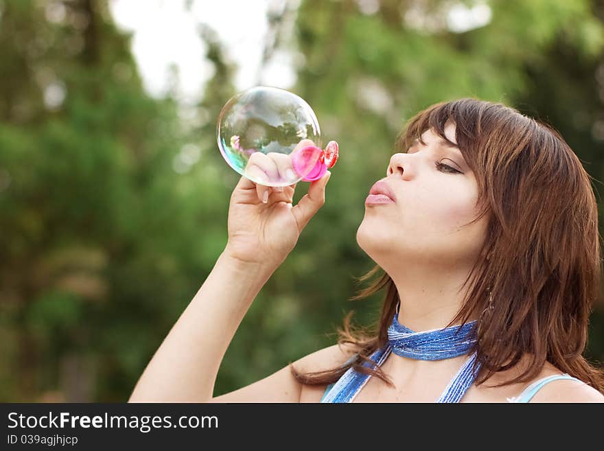 Attractive Girl Inflating Soap Bubbles