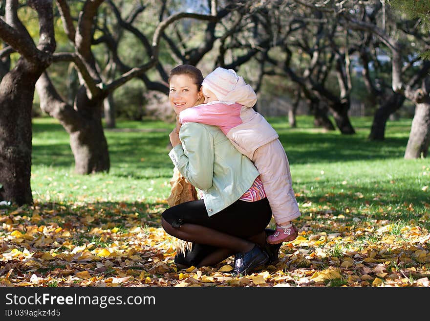 Beautiful woman with her child on back